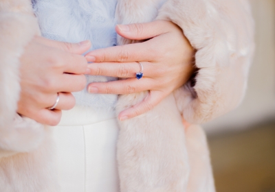 Close up of a woman's hand with blue sapphire engagement ring