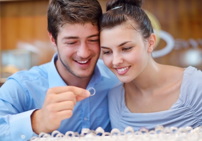 happy young couple in jewelry store