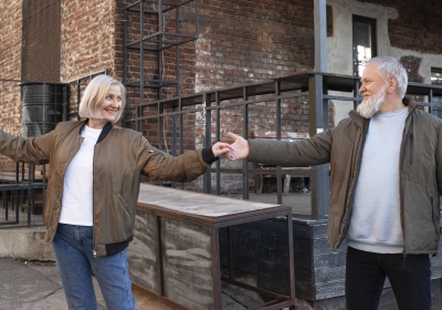 medium-shot-smiley-senior-couple-dancing-outdoors